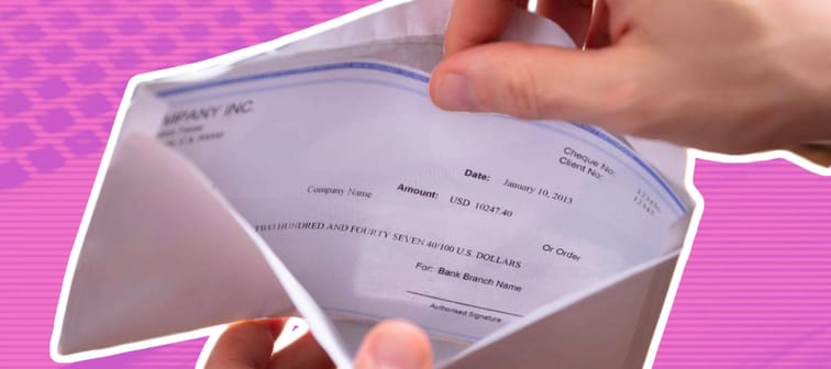 Hands opening paycheck