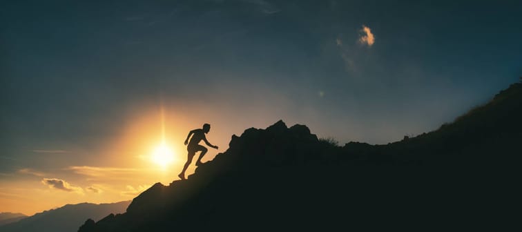 A mountain climber takes on a rocky ridge.